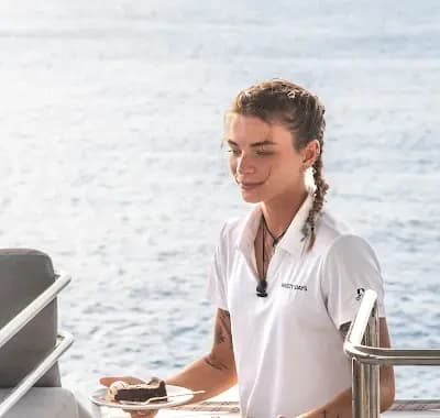 A Breezy Days crew member serving guests on deck