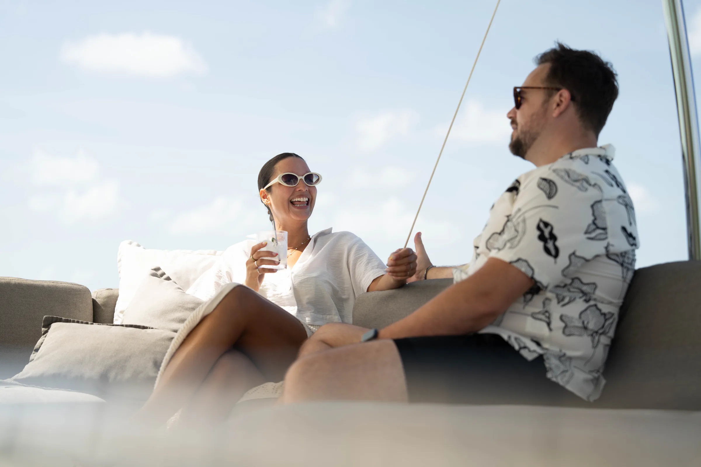 Guests relaxing in the shaded lounge on board