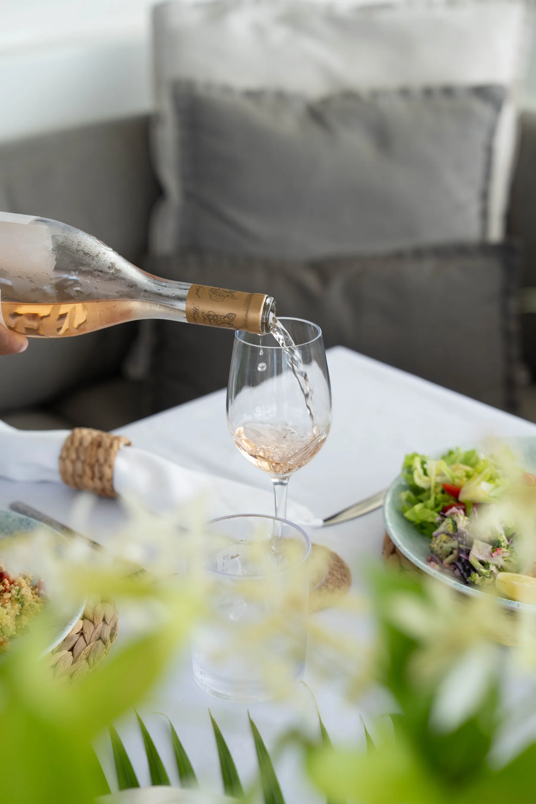 Rose wine poured beside lunch on board
